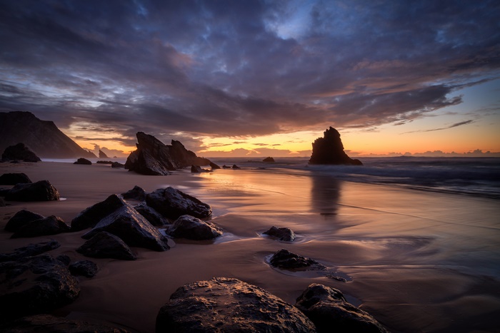 Dramatic sunset over a rocky beach