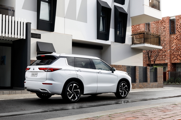 White Mitsubishi Outlander 4K SUV on an urban street