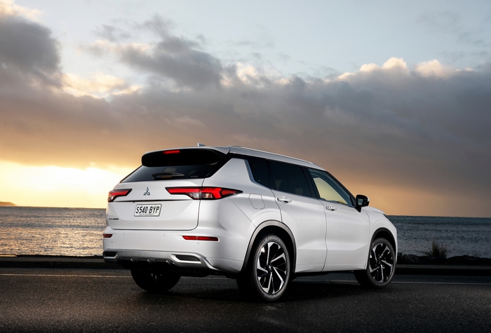 4K White Mitsubishi Outlander SUV by the ocean at sunset