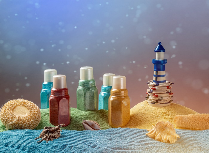Colorful Bath Salts and Spa Products on Beach Sand