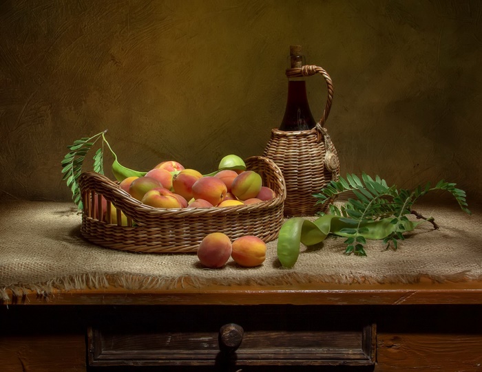 Rustic Still Life with Apricots, Basket, and Wicker Bottle