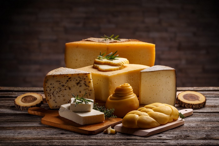 Assorted Cheese Selection on Wooden Boards