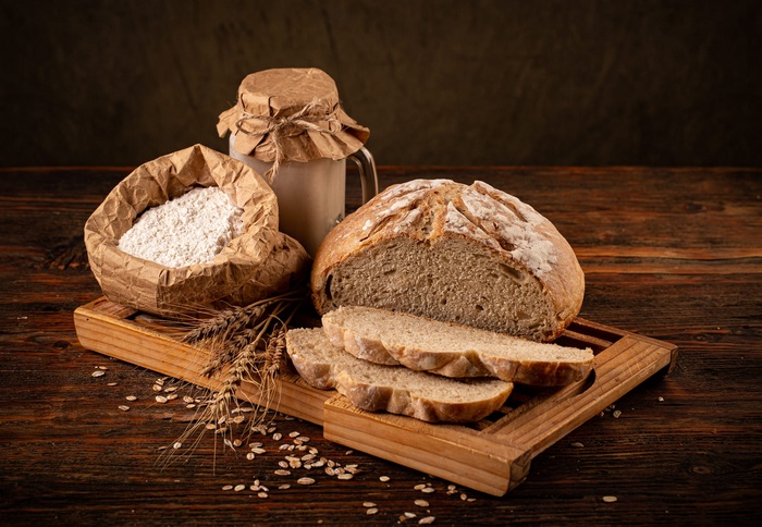 Homemade bread, flour, and sourdough starter