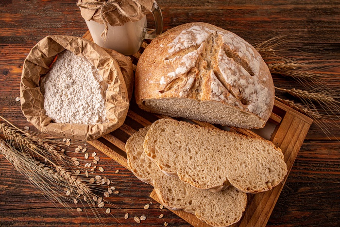 Freshly baked bread with flour and wheat