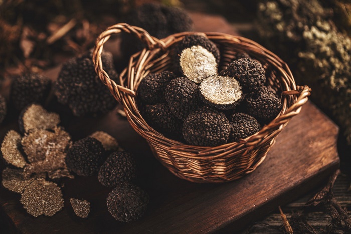 Black Truffles, Whole and Sliced, in a Basket