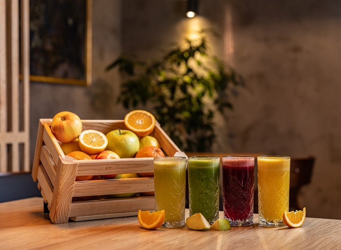 Vibrant Fruit Smoothies and Juices with a Crate of Fruit