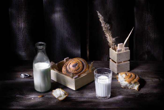 Milk and Viennoiserie Still Life on Dark Wood
