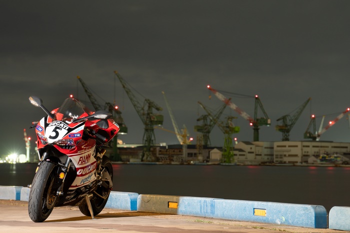 Red Ducati Panigale V4 at Night with Cranes