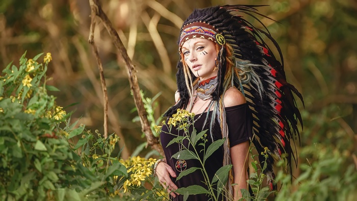 Woman in Native American Headdress and Face Paint