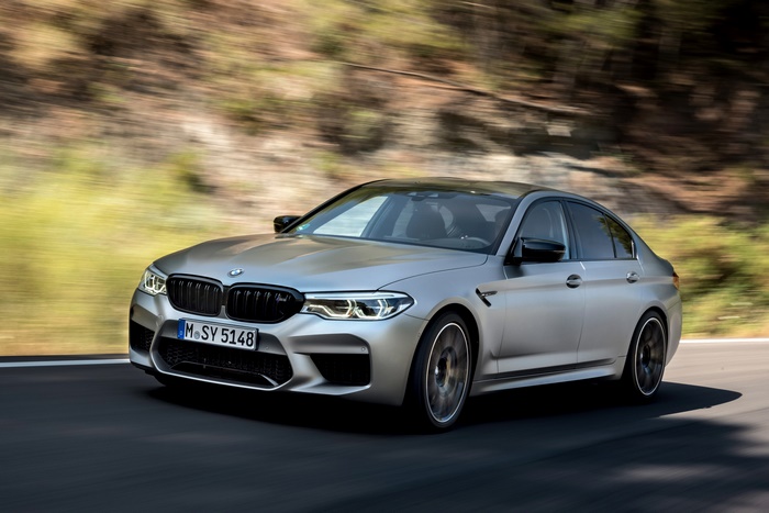 BMW M5 Competition driving fast on a road
