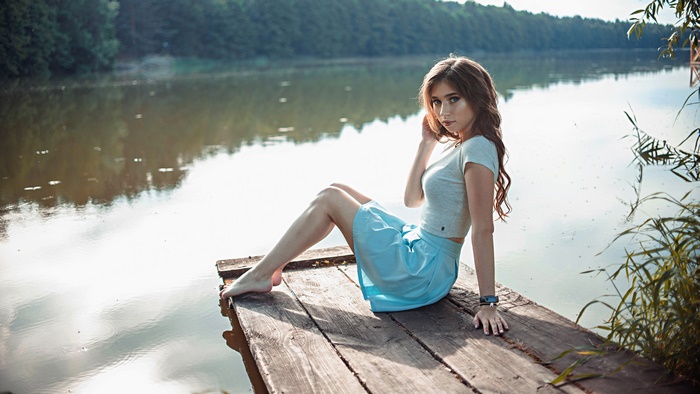 Brunette Model Sitting by the Lake