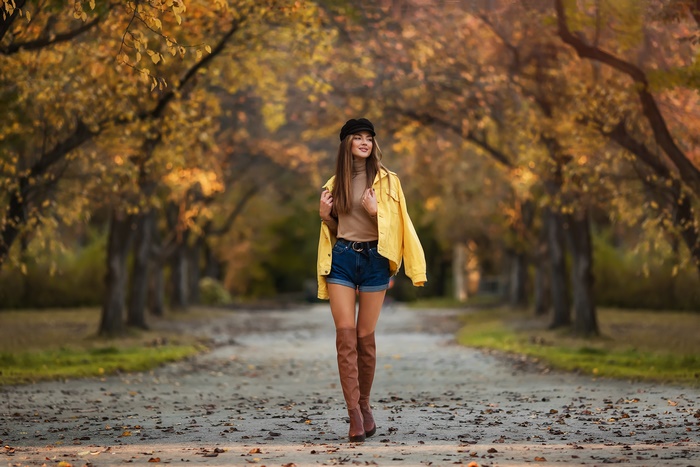 Autumn model in boots with blurred background