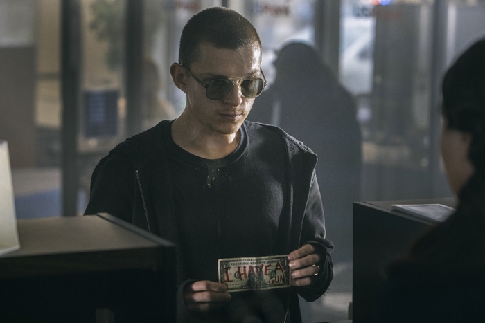 Tom Holland as Cherry holding "I HAVE A GUN" dollar bill