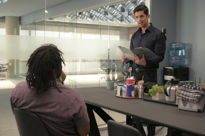 Josh Peck holding a folder in Turner and Hooch