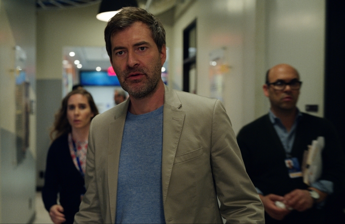Mark Duplass serious in The Morning Show hallway