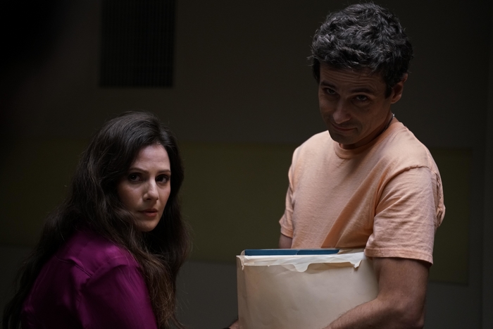 Luke Kirby smirking with Aleksa Palladino looking serious
