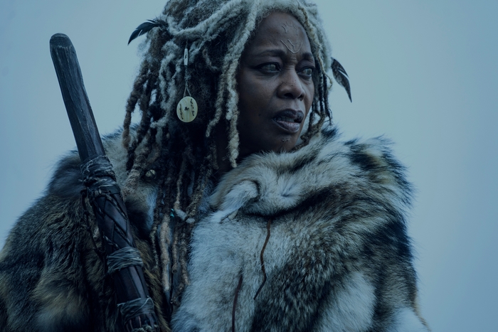 Alfre Woodard in furs with dreadlocks and staff