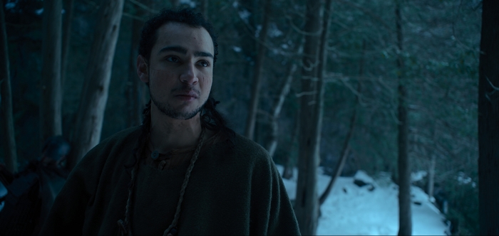 Archie Madekwe in a dark snowy forest