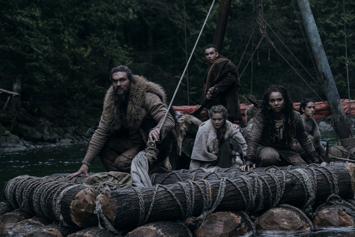 Jason Momoa and companions on a log raft