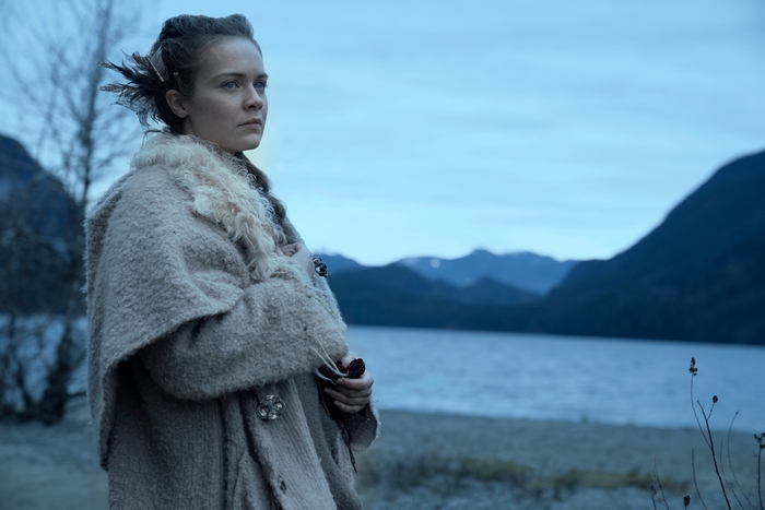 Hera Hilmar in a warm coat by a cold lake