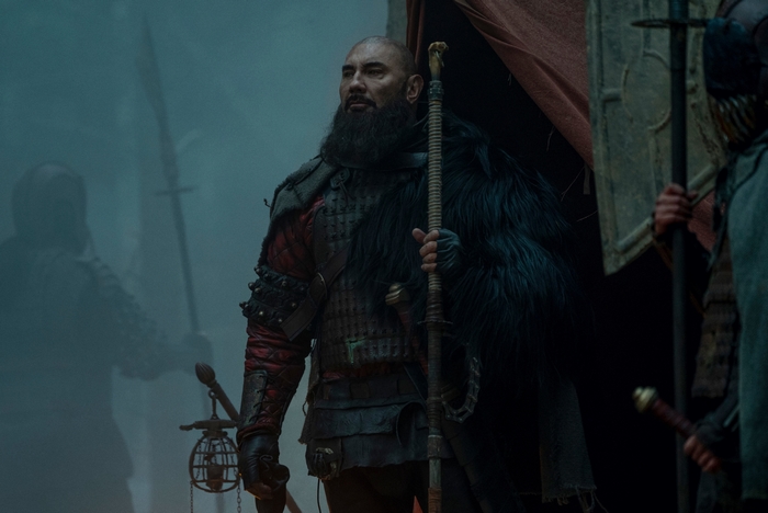 Dave Bautista as a bearded warrior with a staff