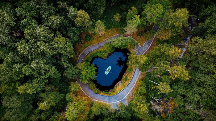 Heart-shaped lake with boat in Ruskeala Mountain Park, Russia