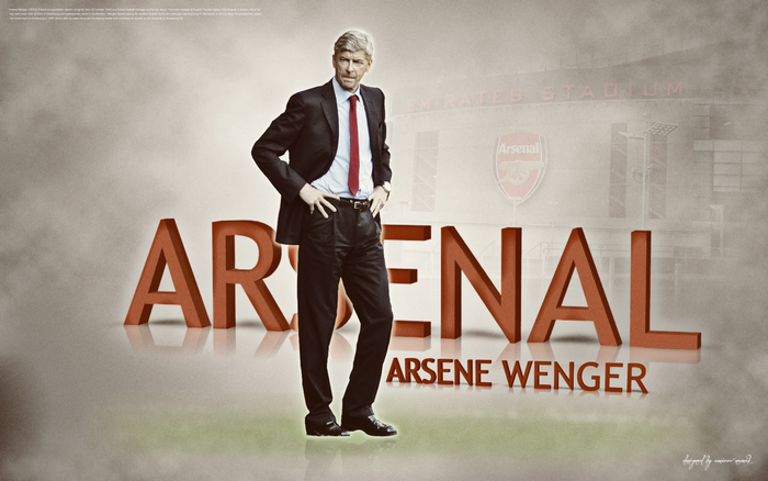 Arsene Wenger standing with Arsenal F.C. branding