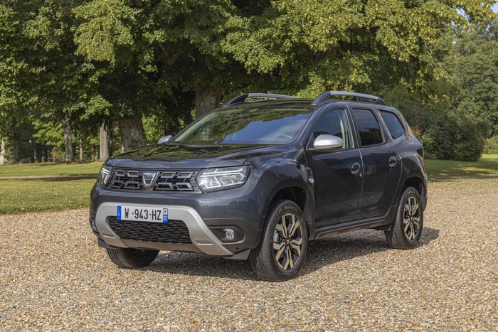 Dark Dacia Duster SUV parked on gravel path