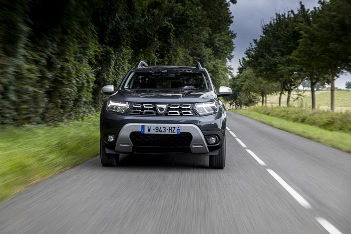 Dacia Duster SUV on a tree-lined road