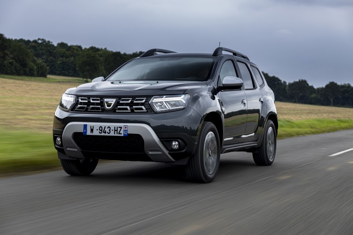 Dark Dacia Duster SUV driving on a road