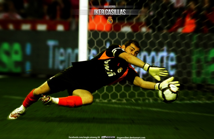 Iker Casillas makes a diving save for Real Madrid