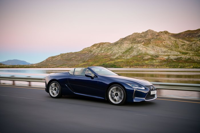 Blue Lexus LC 500 Cabriolet driving on a scenic road