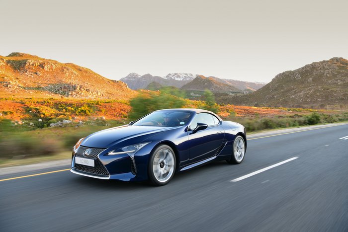 Blue Lexus LC 500 Cabriolet driving on a scenic mountain road