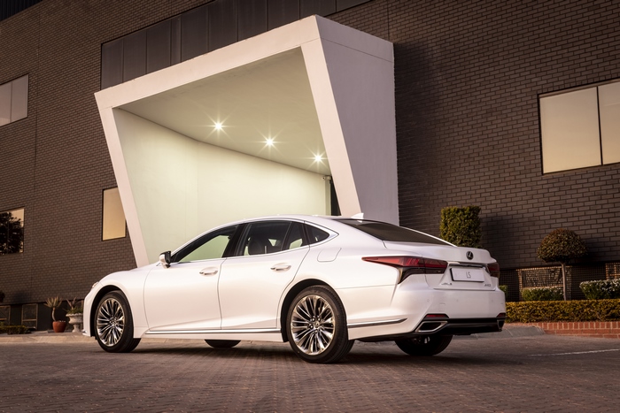 Lexus LS 500 luxury car at modern building entrance