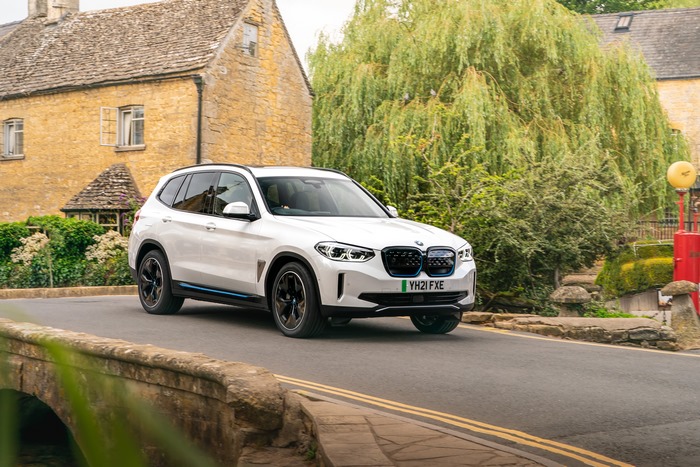 White BMW iX3 electric SUV in a picturesque village
