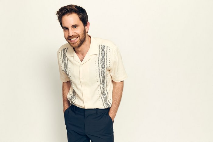 Ben Platt smiling in a patterned shirt