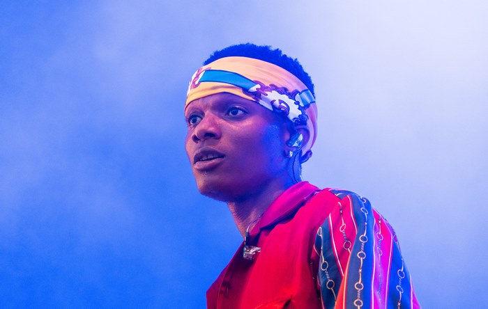 WizKid in red shirt and colorful headband