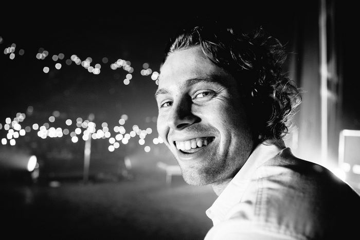 Luke Hemmings smiling black and white with bokeh lights