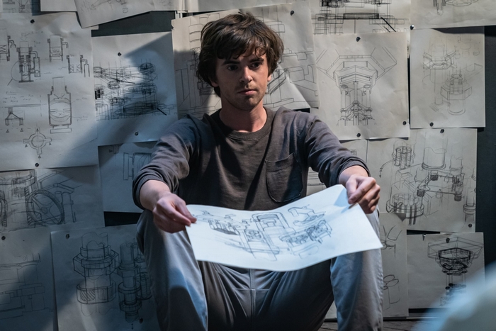 Freddie Highmore holding a drawing in The Vault