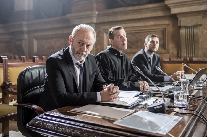Liam Cunningham serious in The Vault (2021) courtroom