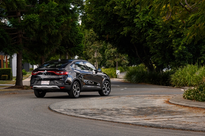 Black Renault Arkana SUV on a winding road