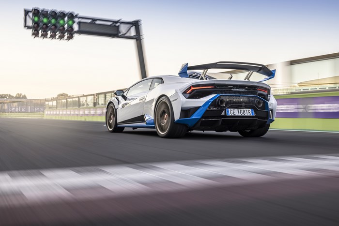 Lamborghini Huracán STO supercar accelerating past green lights