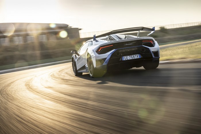 Lamborghini Huracán STO cornering on track with sun flare