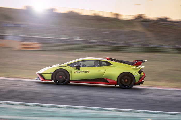 Green Lamborghini Huracán STO speeding on track
