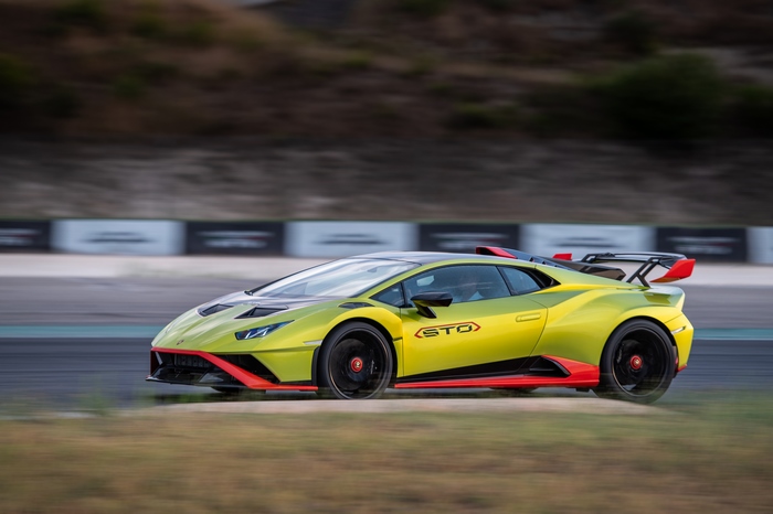 Green Lamborghini Huracán STO speeding on track