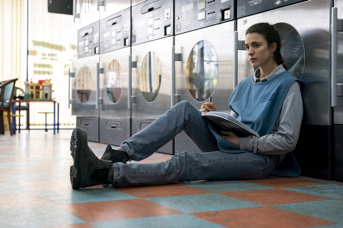Maid: Margaret Qualley sitting in laundromat