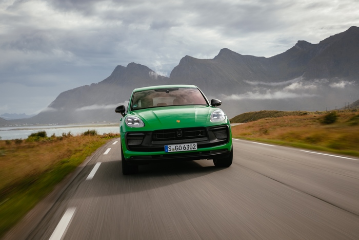 Green Porsche Macan GTS SUV on a scenic mountain road