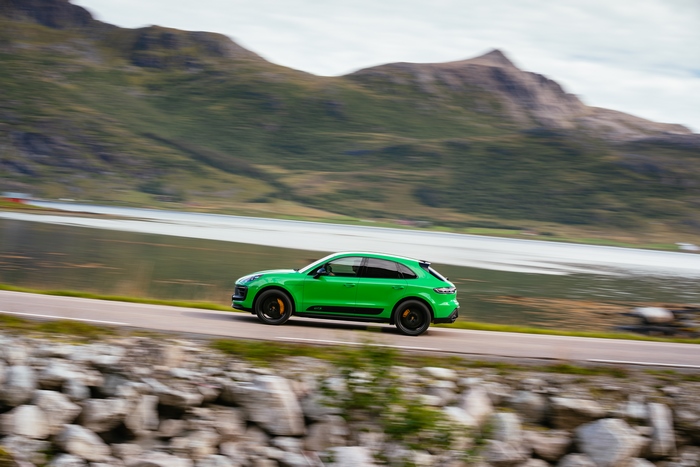 Green Porsche Macan GTS SUV driving on a scenic road