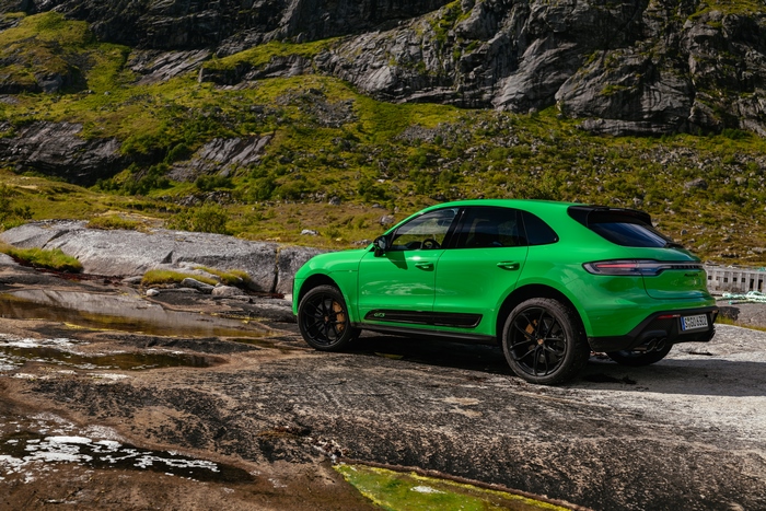Green Porsche Macan GTS SUV on rocky terrain