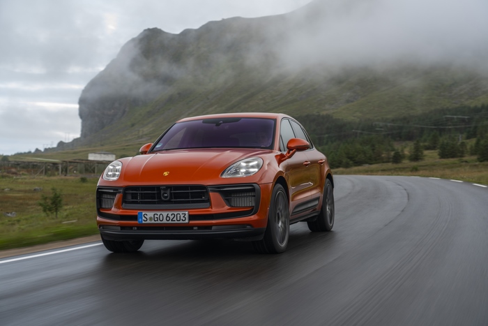 Orange Porsche Macan S SUV on a winding road